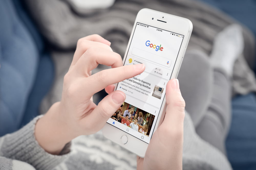 Shutterstock_1017761755  Kyiv, Ukraine - January 24, 2018: Woman using Google app on Apple iPhone 8 plus at home. Google it is the most-used search engine on the World , handling more than three billion searches each day